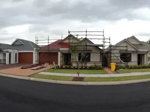 Professional roofer inspecting a residential roof in Ballina, showcasing affordable roof replacement services
